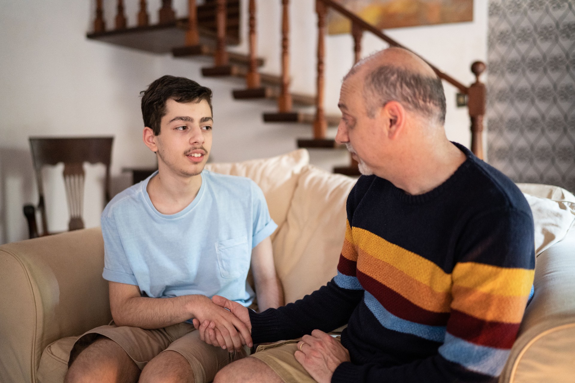 Father and son talking at home